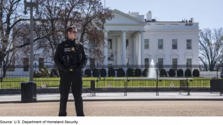 Photo of Secret Service member in front of White House