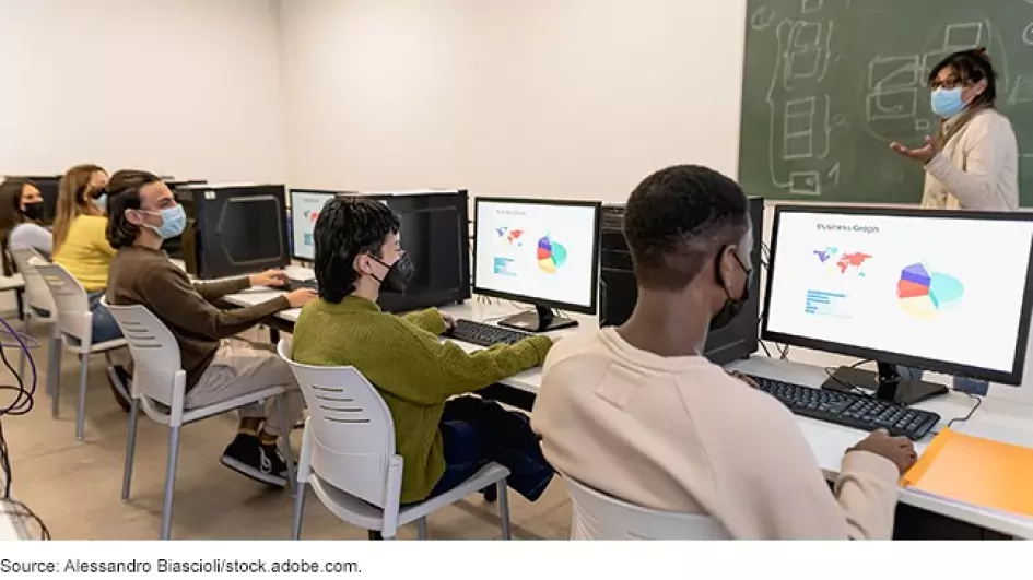 Photo showing students sitting at computers during a class