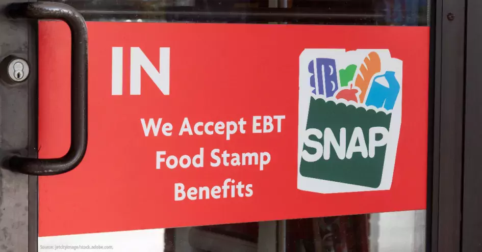 The door to a store with a sign that reads "We accept EBT Food Stamp Benefits--SNAP"