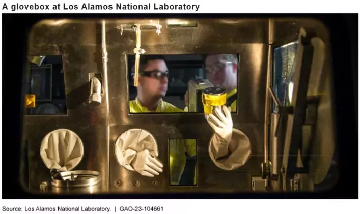 A photo showing a person using a glovebox at a plutonium facility at Los Alamos National Laboratory