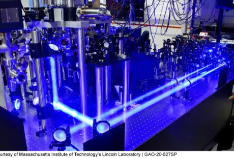 The image shows a trapped ion qubit (a quantum bit) test bed in the Quantum Information and Integrated Nanosystems Group at Lincoln Laboratory.