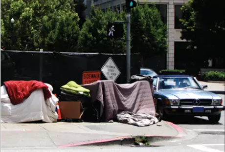Photo showing shelters created by homeless persons on sidewalk.