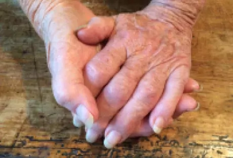 Photo of hands clasped together. 
