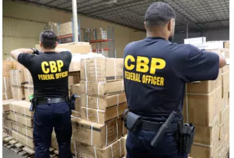Customs and Border Protection agents inspecting a detaining shipment of hair products from China