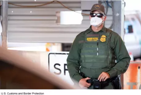 Photo showing a Customs and Border Patrol agency with a mask on to protect against COVID-19