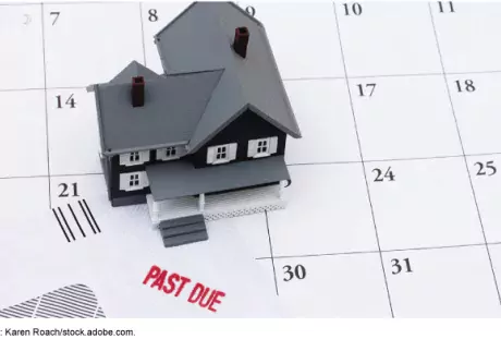 Illustration of a toy house on top of a calendar showing an overdue bill