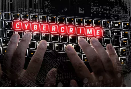 Illustration of a computer keyboard with the word "cybercrime" highlighted in red on the keys.