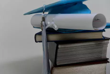 Photo Showing Mortarboard, Diploma, and Books