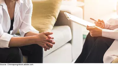 Stock image showing two people--a counselor and someone receiving counseling. 