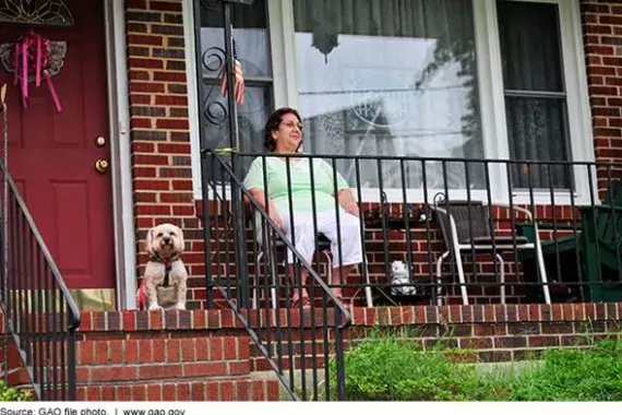 Photo of an older woman sitting on her porch.