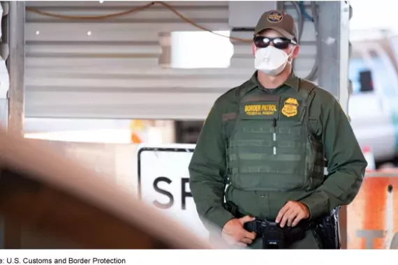 Photo showing a Customs and Border Patrol agency with a mask on to protect against COVID-19
