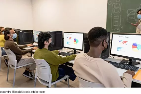 Photo showing students sitting at computers during a class