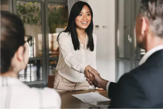 People shaking hands during a job interview. 