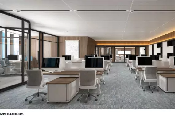 Photo showing an office space with desks and chairs, but not employees