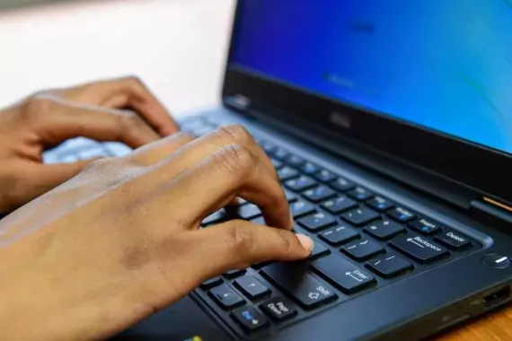 Photo showing hands on a laptop computer keyboard